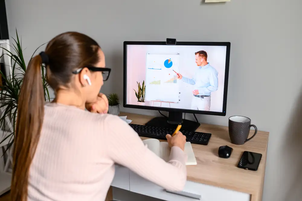Woman watching webinar - 6 Ideas That Will Enhance Your Webinar Marketing