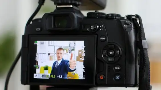 smiling salesperson talking to camera - 3 Ways a Video Strategy Can Fuel Your Sales Team Endeavors - Clipchamp blog