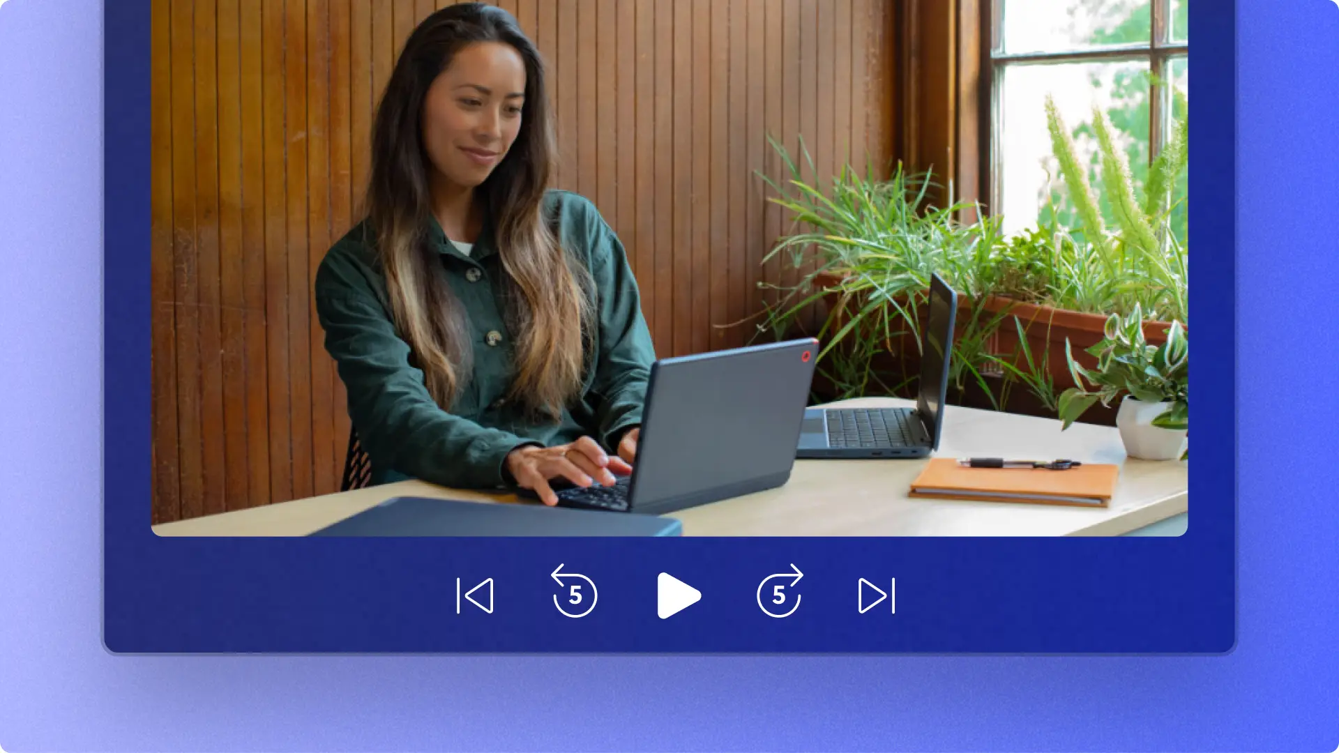 En arbejdende fagperson skriver på en bærbar computer i et abstrakt forhåndsvisningsvindue i Clipchamp-videoeditoren.