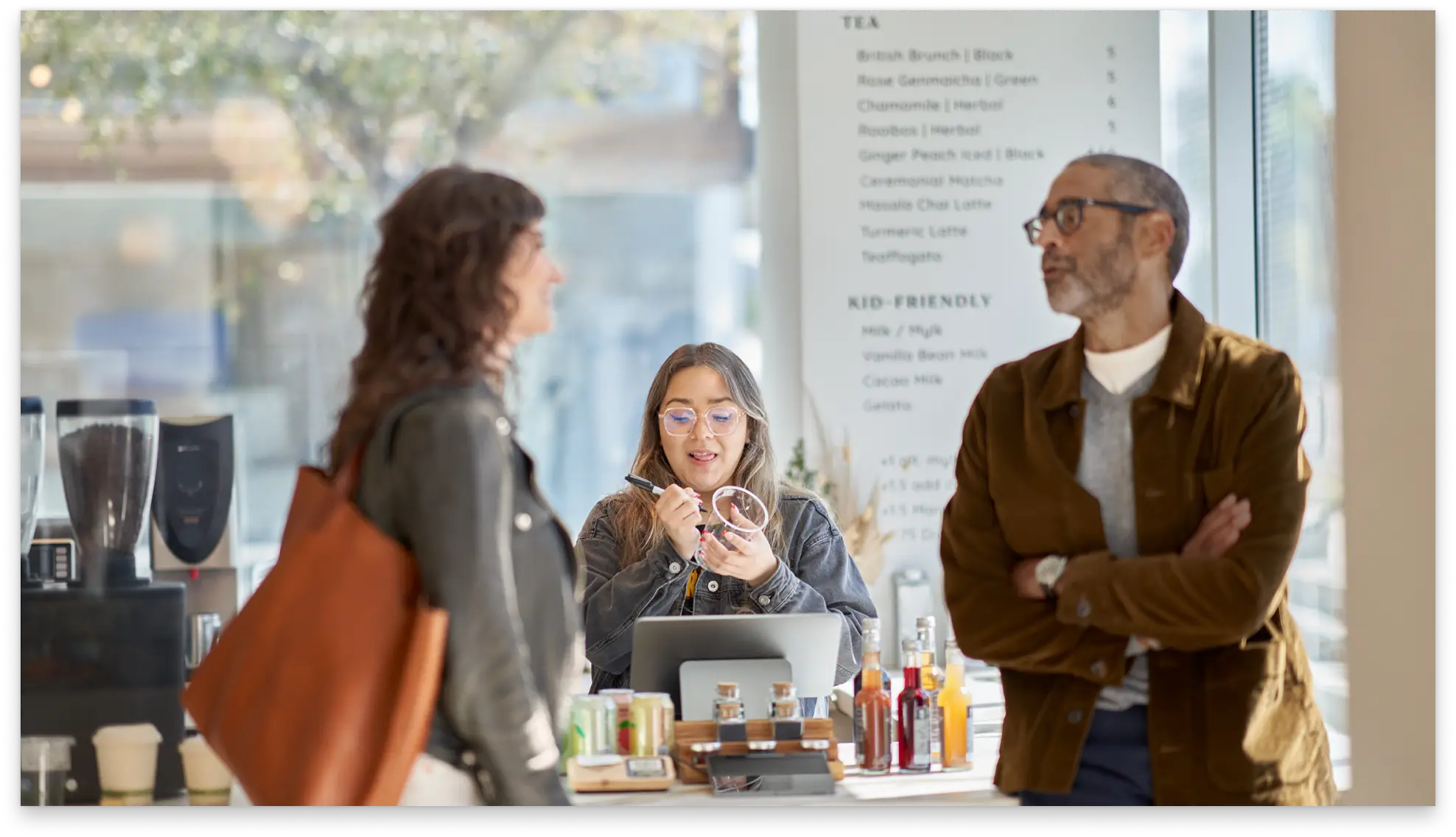 Three people talking at a cafe