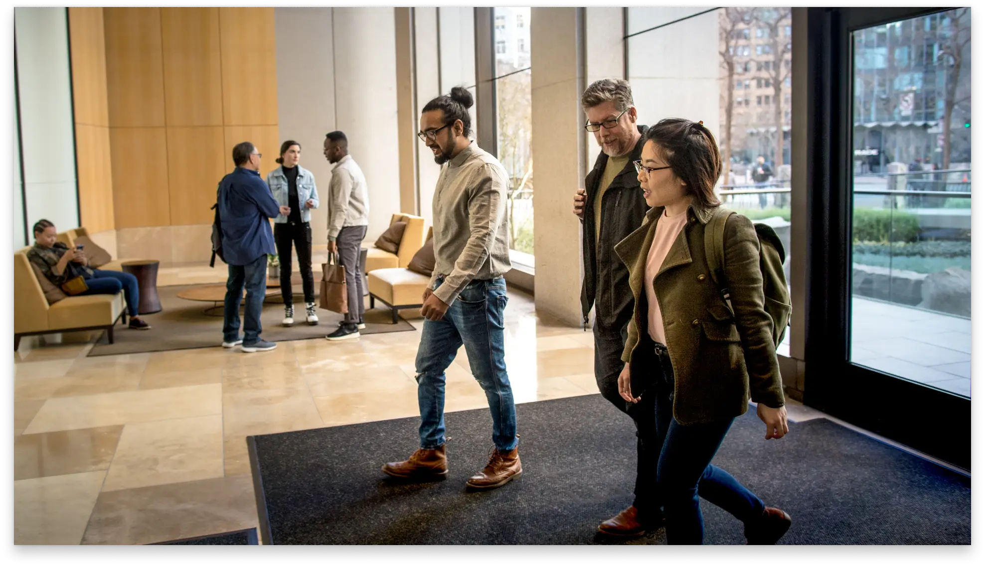 A group of people walking into an office