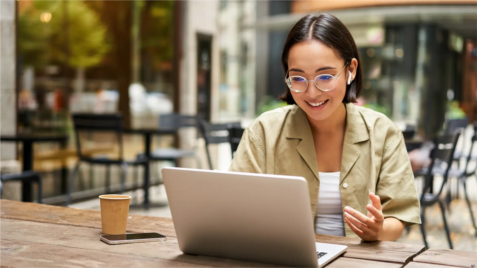 A woman working on a laptop at a cafe