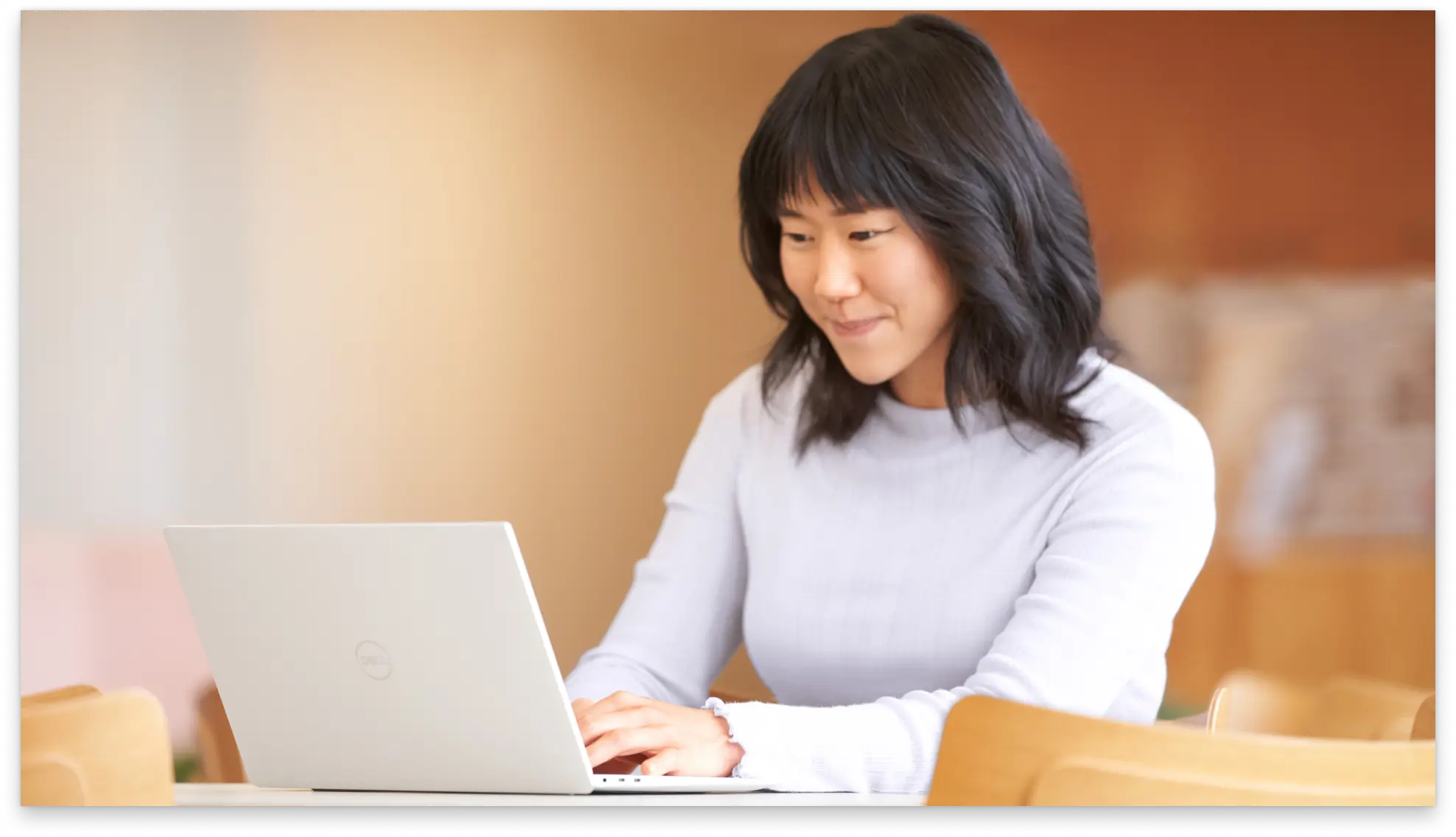 Person sitting at a desk using a laptop, with overlay text ‘Track time for invoice generation’