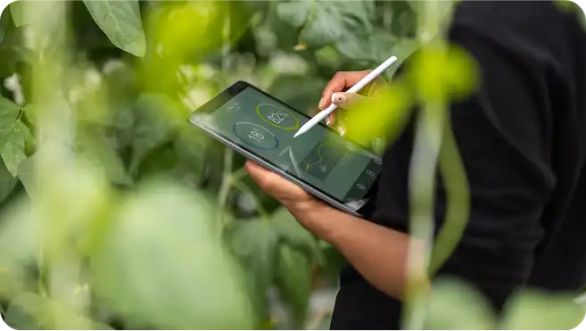 A woman writing on a touch pad.