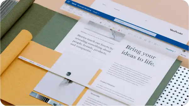 workspace with laptop displaying Word document on storytelling, surrounded by colored paper and a ruler