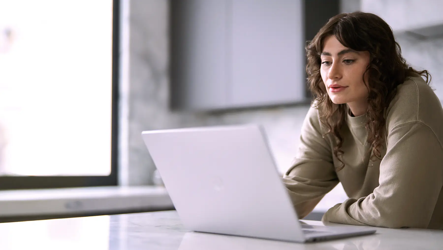 A woman typing on a computer.