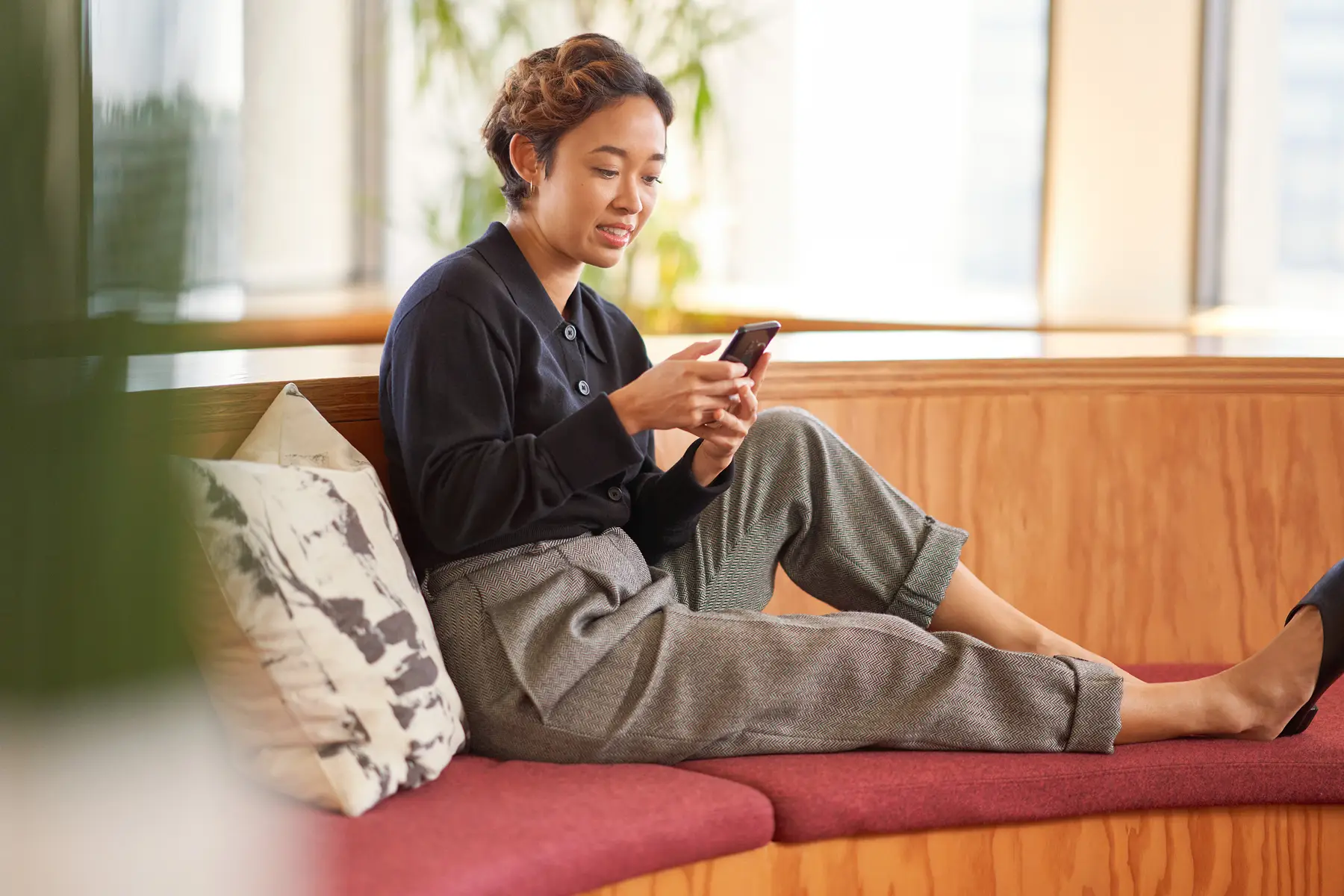 A woman scrolling content on her phone.