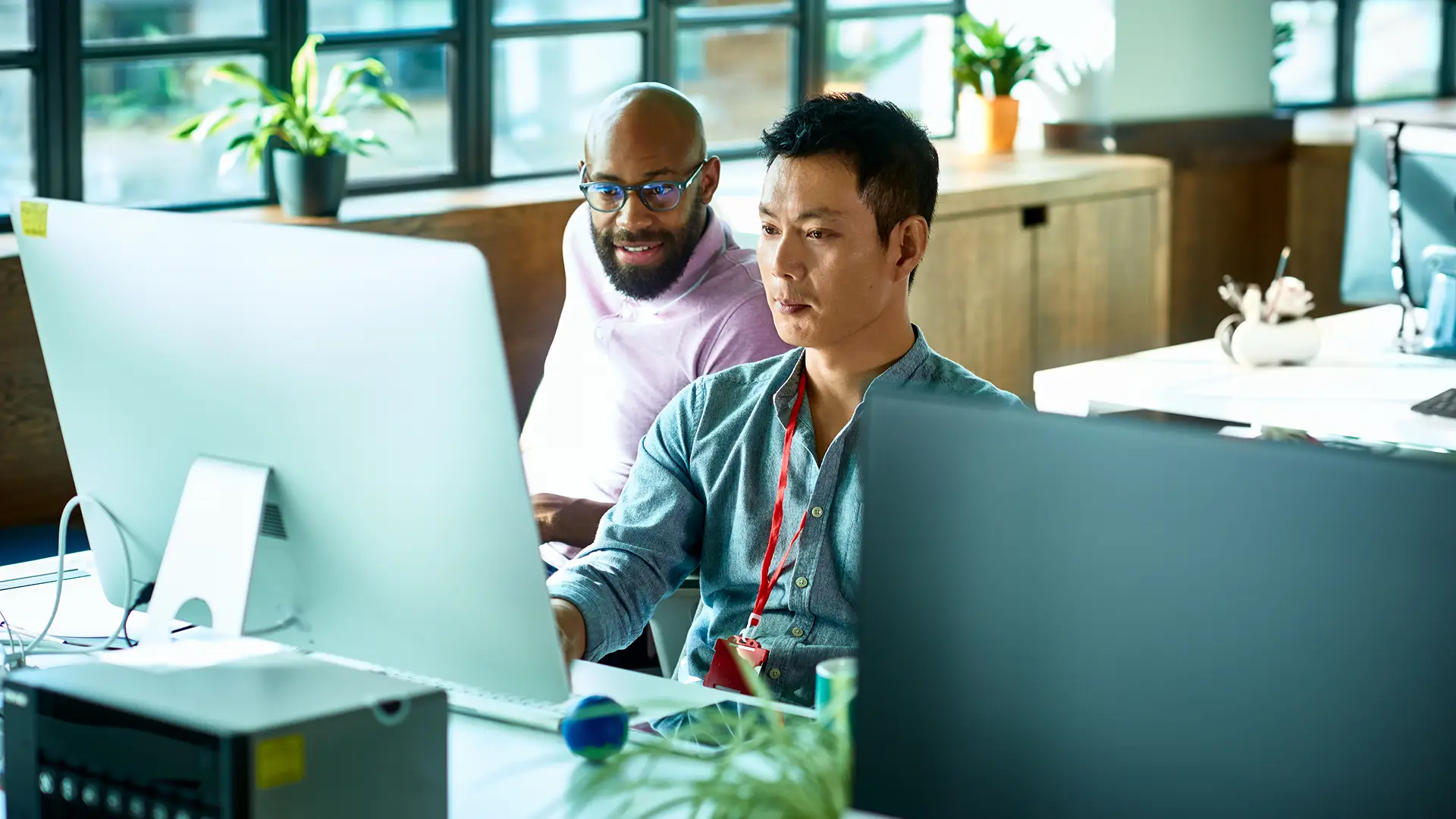 Two people looking at a computer screen.