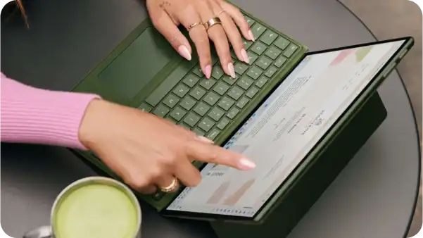 A user pointing to a computer screen.